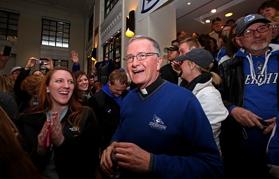 Fr. Timothy Lannon, SJ, with Creighton students and alumni